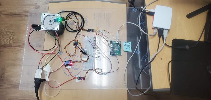 The instrumented rig showing the motor, sensor mounts, breadboard wiring, Arduino and single-board computer.